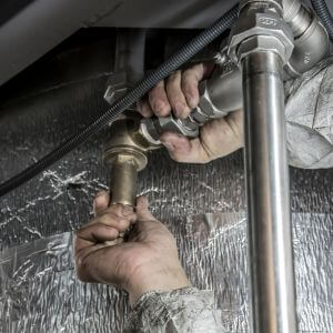 person fixing a leak